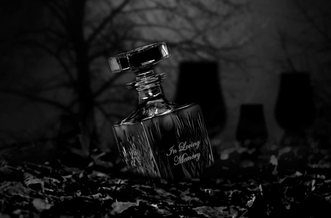 ONE-WITH-THE-GLASS Dark Image showing a crystal decanter with "in loving memory" engraved on it